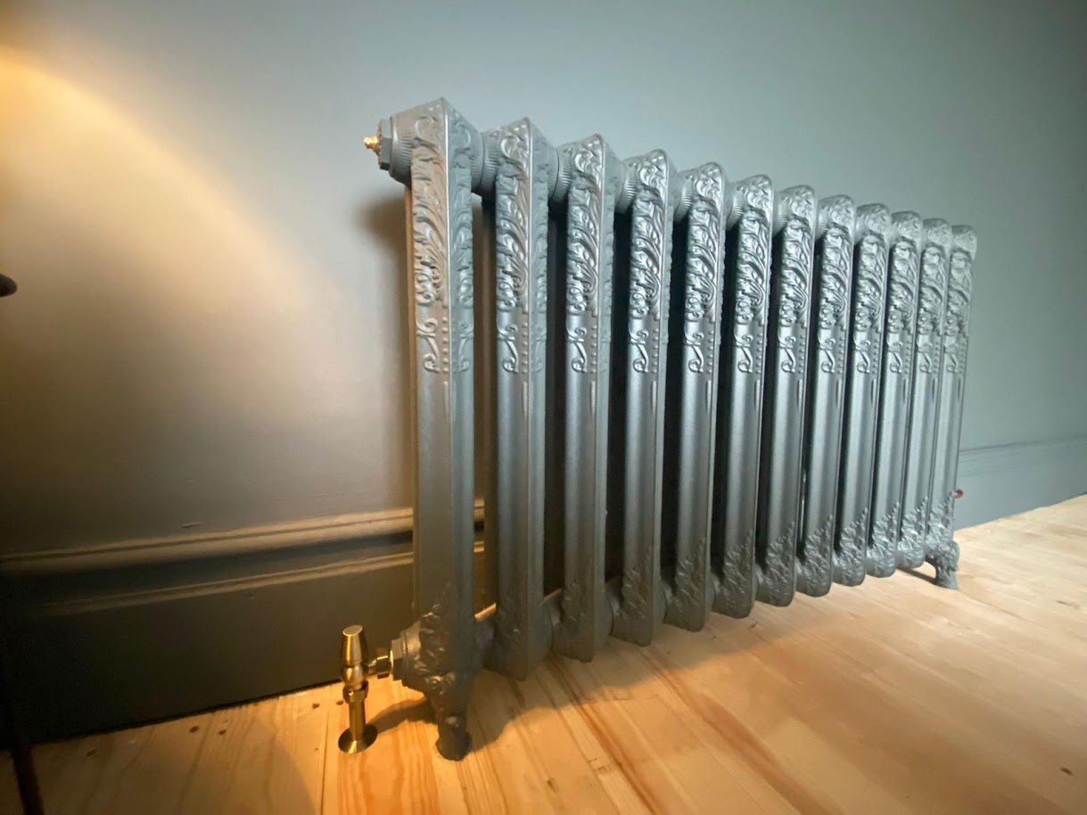 Ornate cast iron designer radiator installed by F.G. Welch heating engineers in Wigan