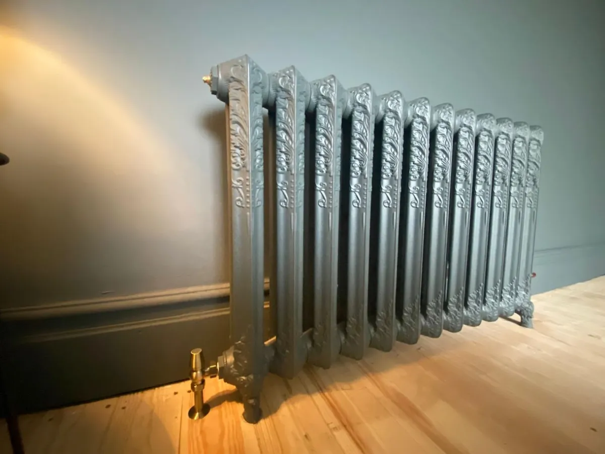 Ornate cast iron designer radiator installed by F.G. Welch heating engineers in Wigan