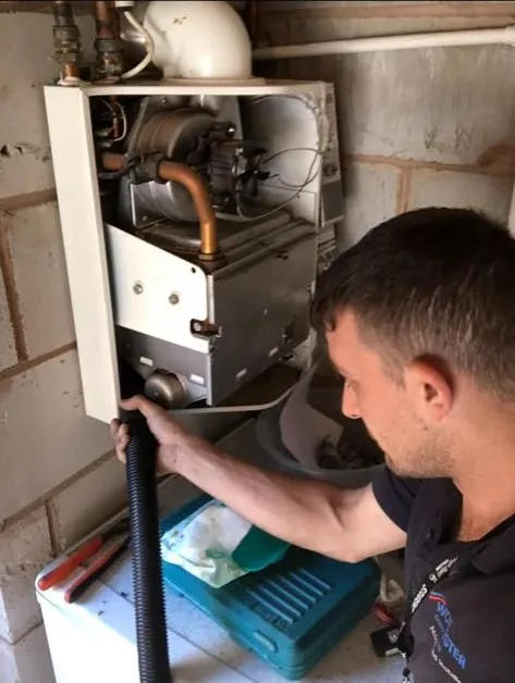 Gas Safe registered engineer performing boiler safety checks in Wigan